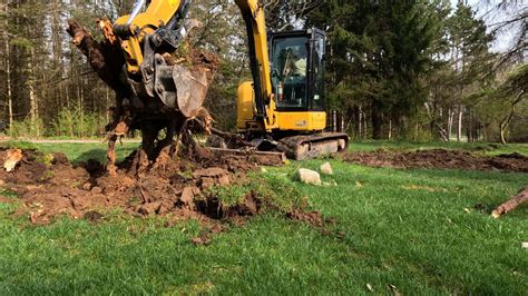 how to remove tree stumps with a mini excavator|pulling out stumps with excavator.